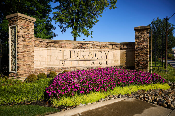 Legacy Village Entrance Sign with flowers below