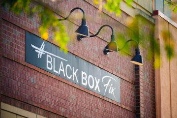 Black Box Fix sign on a brick building at the outdoor shopping mall Legacy Village